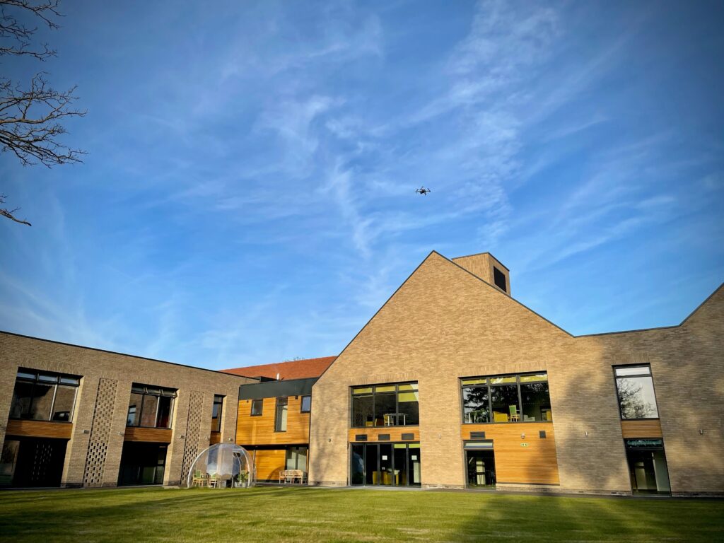 Outside view of the Care and Rehabilitation Centre with a blue sky and shadows across the grass