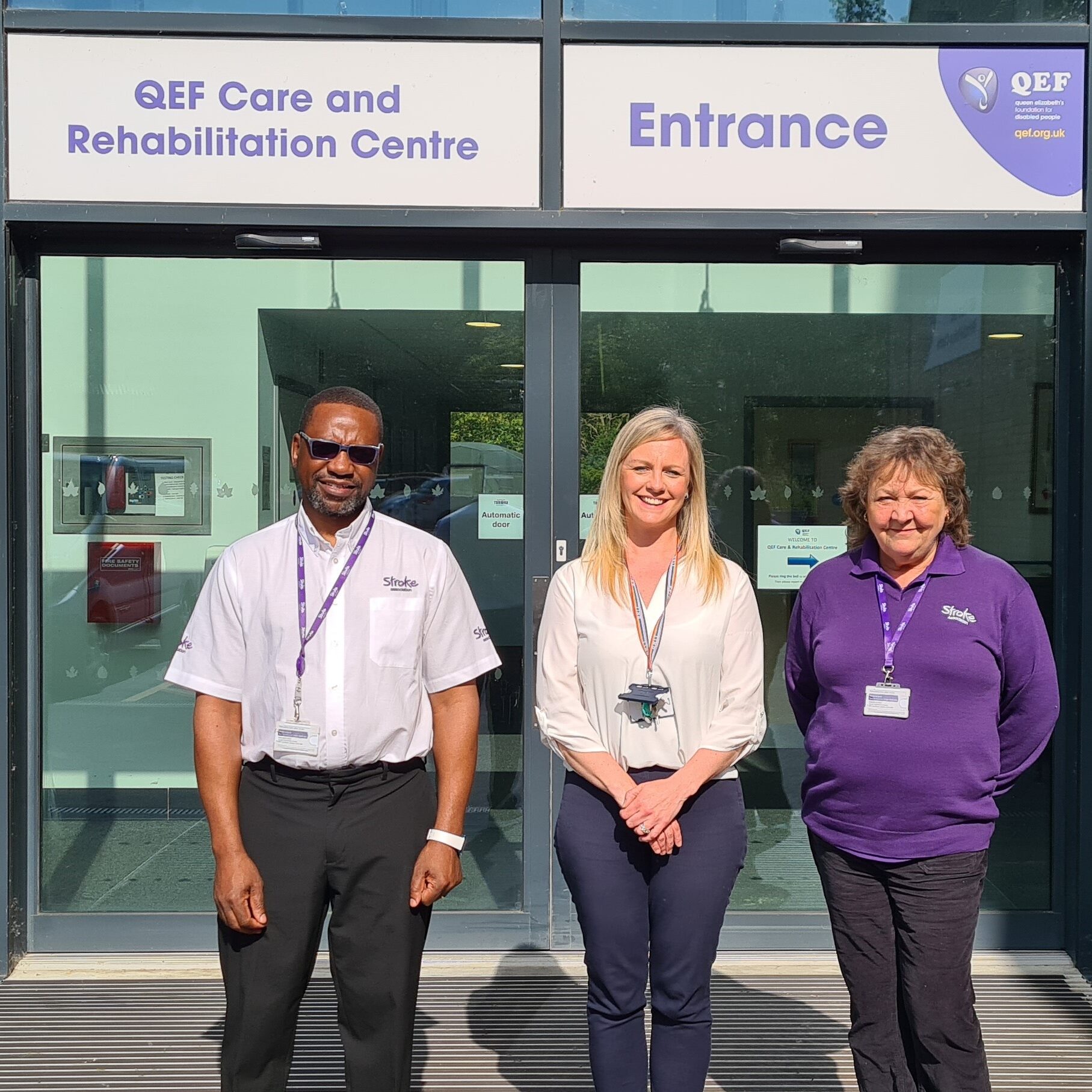 Jenny from QEF with Julie and Arnold from the Stroke Association outside the main entrance to the Care and Rehabilitation Centre